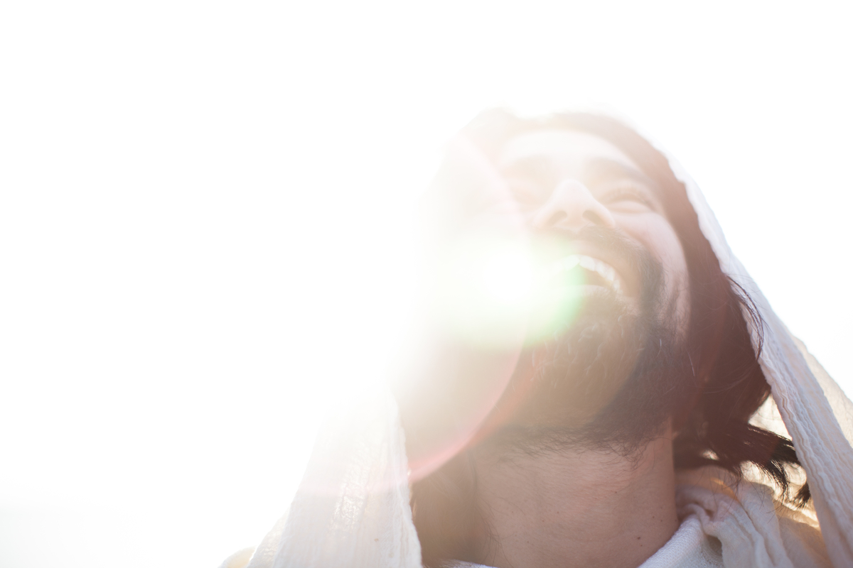 Jesus joyfully smiling in bright white light